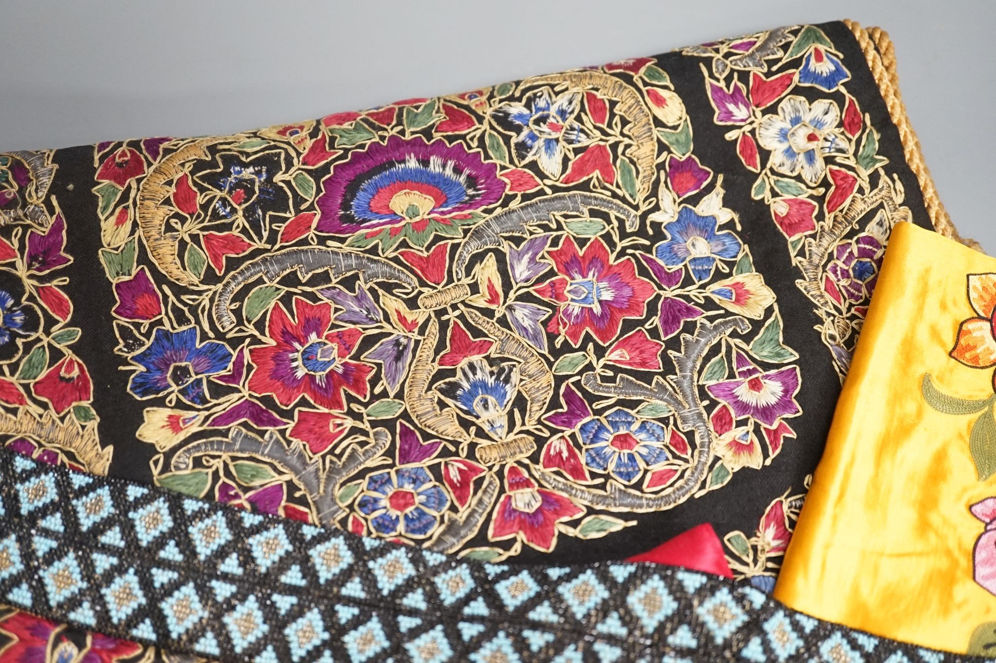 A Berlin beadwork panel , another, a beaded cushion, a book and embroidered banners, 2 silk panels etc